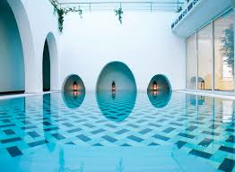 A view at the swimming pool inside the building with white interiors